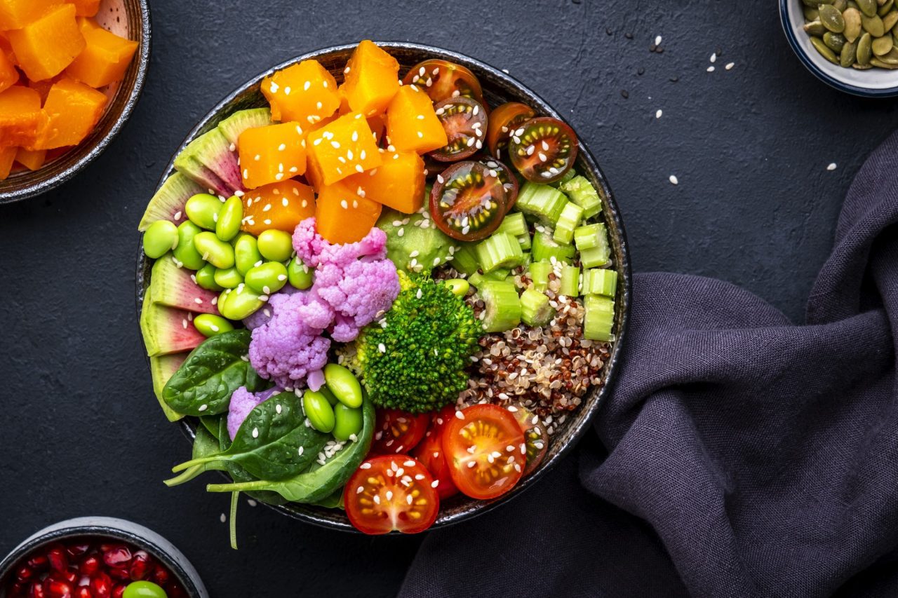 vegan buddha bowl with pumpkin quinoa tomatoes spinach edamame tofu cauliflower broccoli